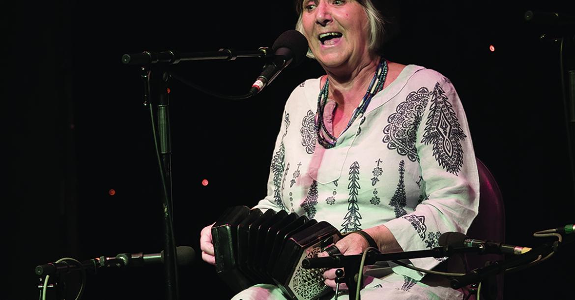 Photograph of Sandra Kerr with concertina in hand